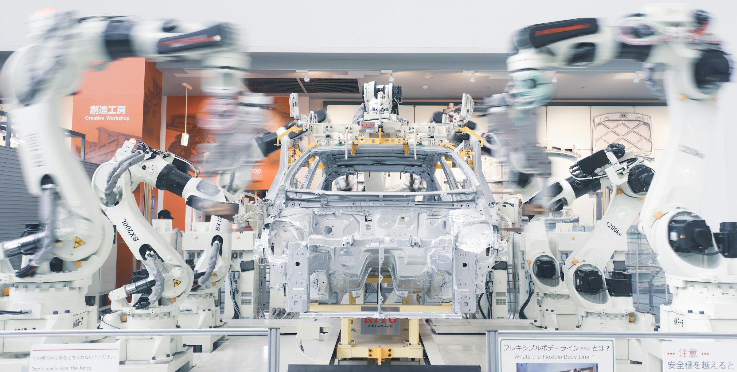 Industrial robot cell in an automated vehicle assembly line